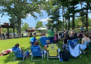 Attendees enjoy amplified song swaps on the lawn at Heckscher Park during the 2021 Huntington Folk Festival. This year's festival will feature song swaps on both the lawn and on the park's Chapin Rainbow Stage.